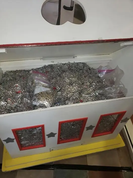 The donation box at the Ronald McDonald house, filled with pull-tabs from cans.