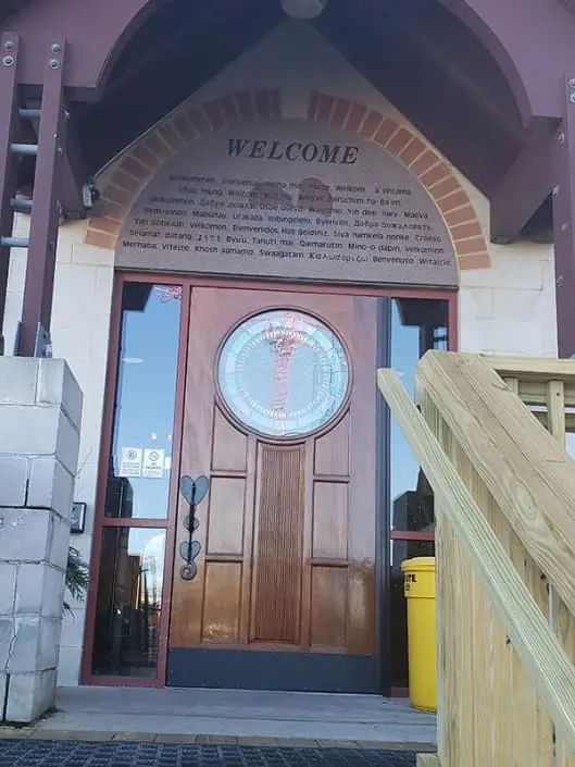 The front door of the Ronald McDonald House. Above it is a slate that reads the word "Welcome" in several different languages.
