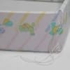 Crib bumper detail of product corner and colorful teddy bear design